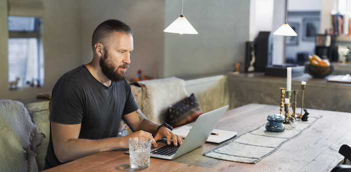 person working at dining table at home