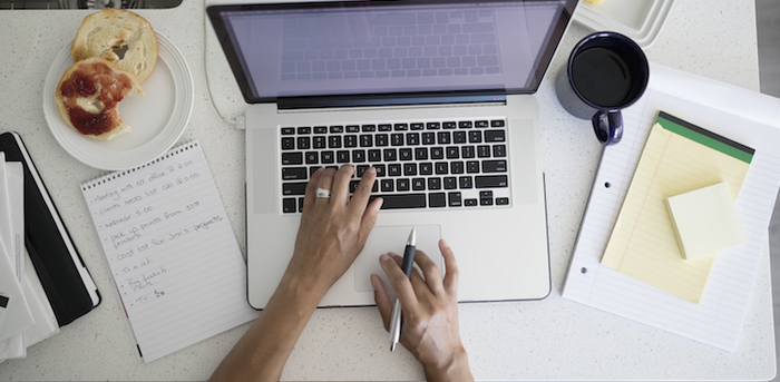 person typing and using the mouse pad on a laptop