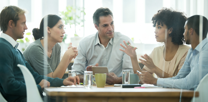 co-workers having a discussion in a conference room