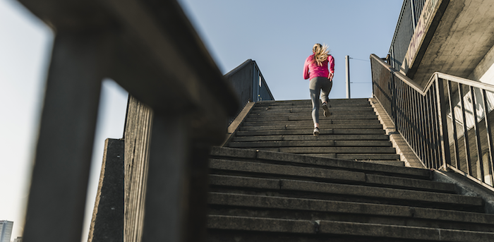 person running up a set of steps outside