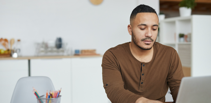 person sitting at home working on a laptop