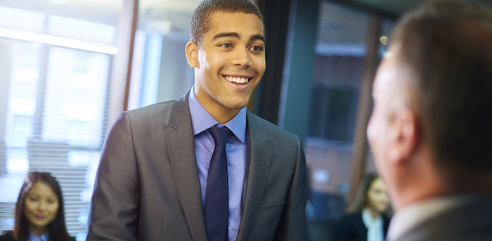 person shaking hands upon arriving for an interview