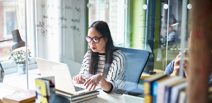 person using laptop in an office