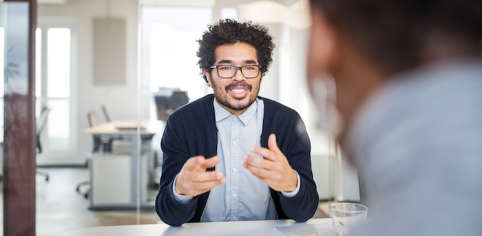 person sitting and talking at a job interview