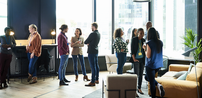 people standing around in an office chatting