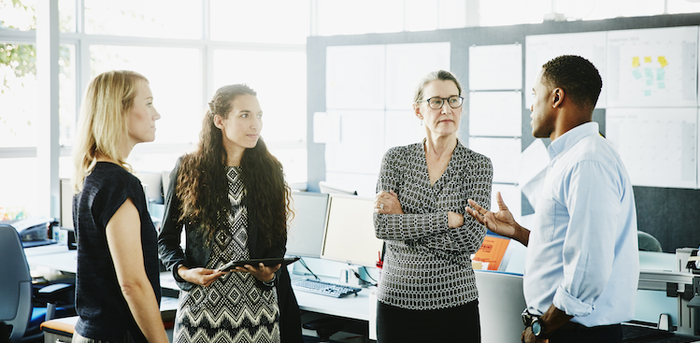 people standing in an office talking