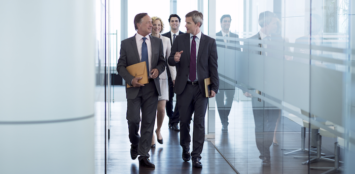 people walking down the hall in an office