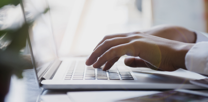 hands on a laptop keyboard