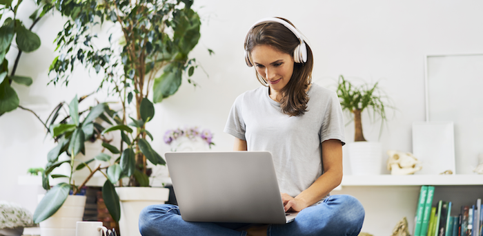 person on laptop with headphones