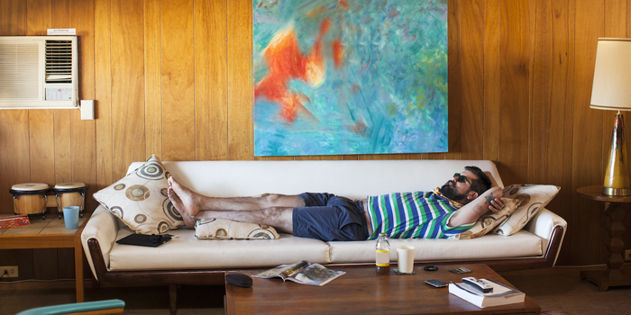 person stretched out on a couch relaxing