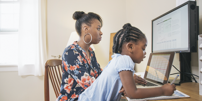 parent working from home with their child nearby