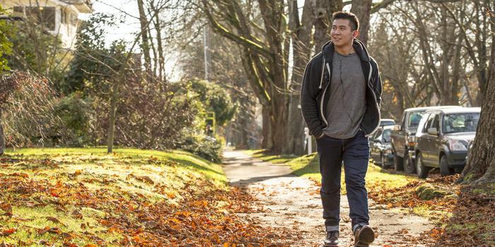 person taking a walk and speaking on the phone with headphones