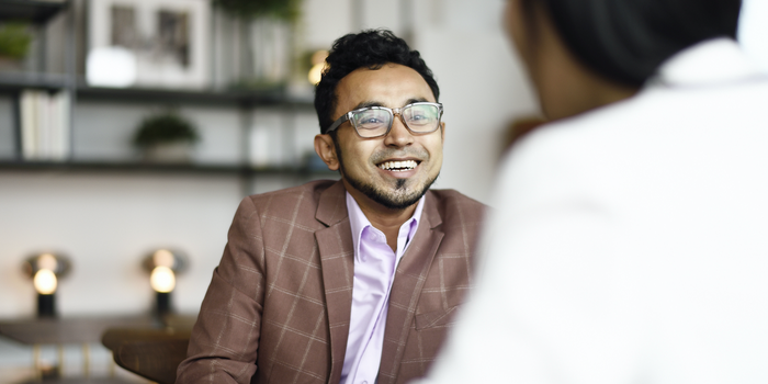 person sitting across from an interviewer during a job interview