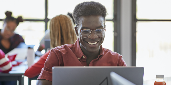 student sitting and working on a laptop