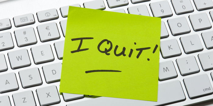 sticky note with "I quit!" on a computer keyboard