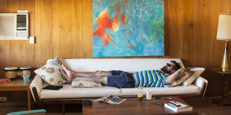 person stretched out on a couch relaxing