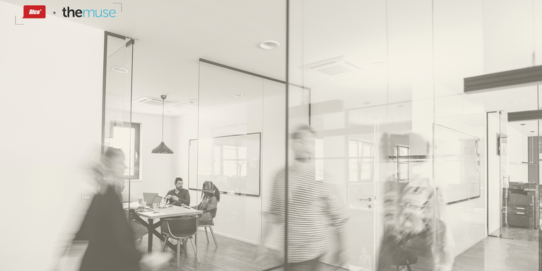 blurred images of people passing quickly in a hallway outside of a conference room in an office