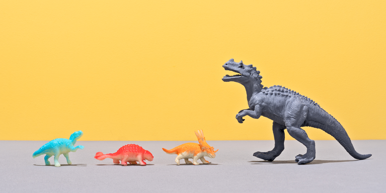 one large gray dinosaur facing three much smaller colorful dinosaurs against a yellow background