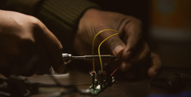 hands assembling electronic parts